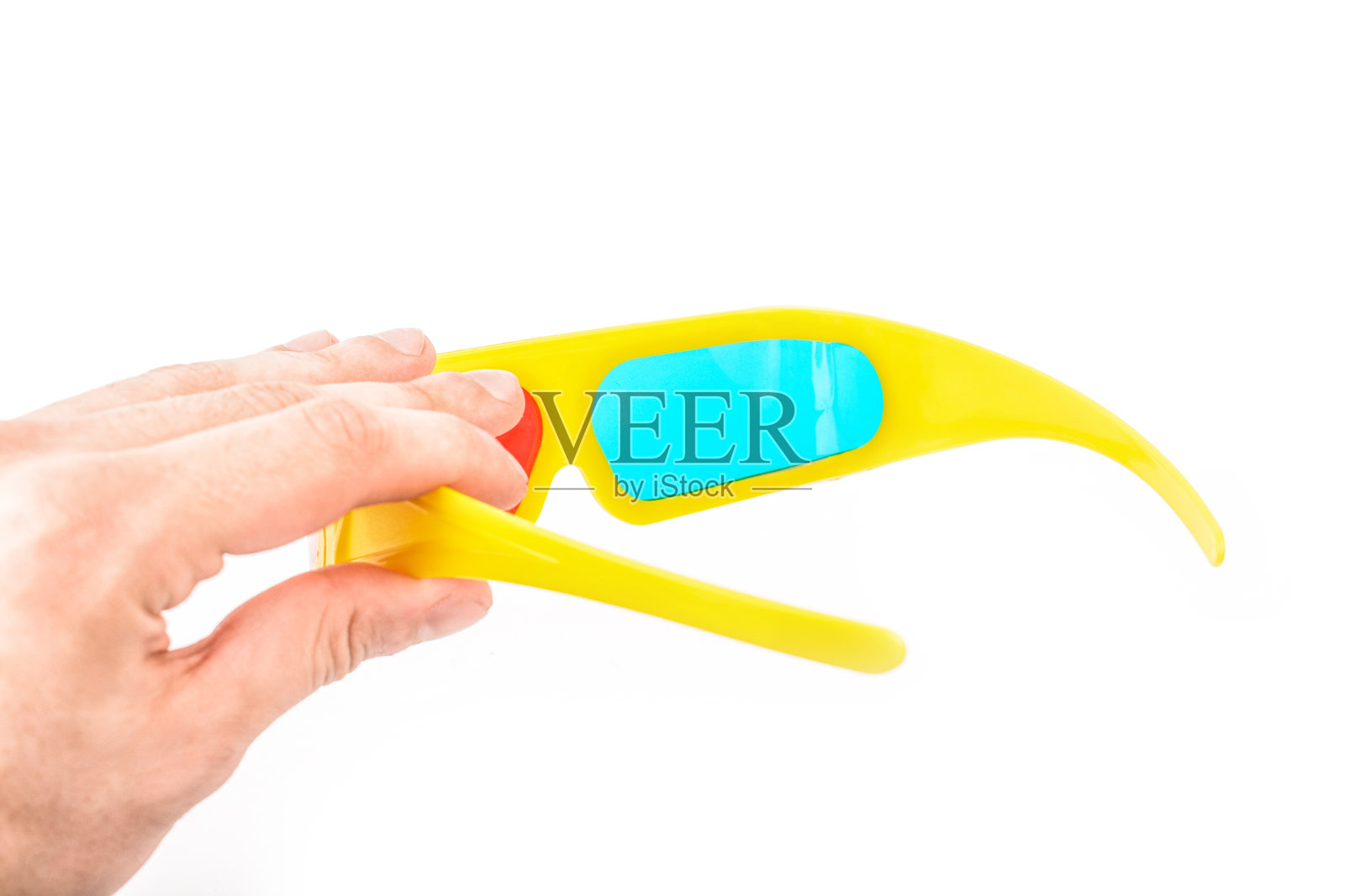 黄色立体眼镜在白色的背景上在手照片摄影图片