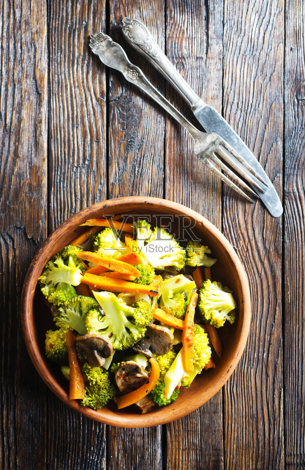 在碗中翻炒蔬菜。西兰花，胡萝卜和洋葱照片摄影图片