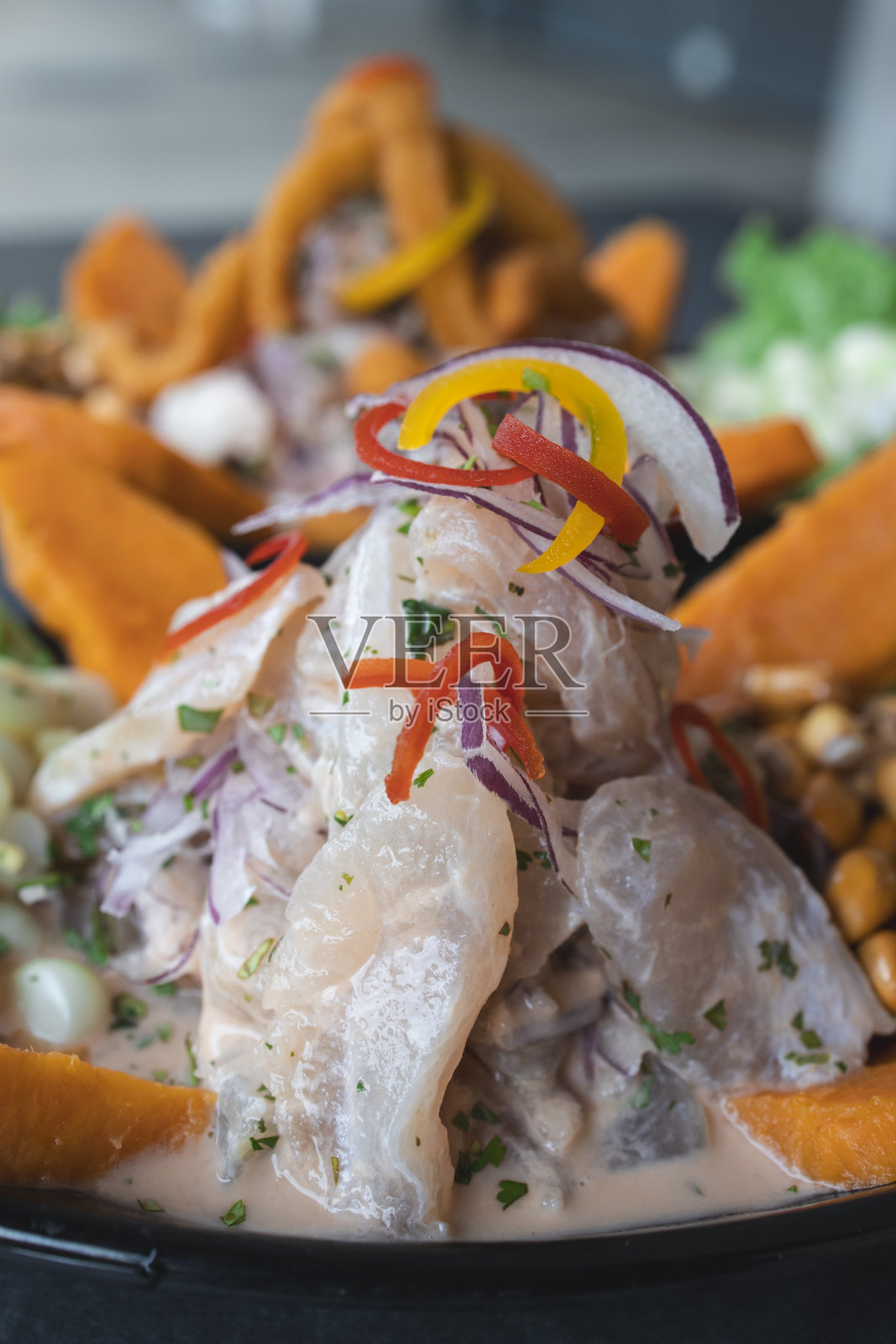 秘鲁传统菜肴的特写。用腌制过的鱼解开。垂直拍摄照片摄影图片