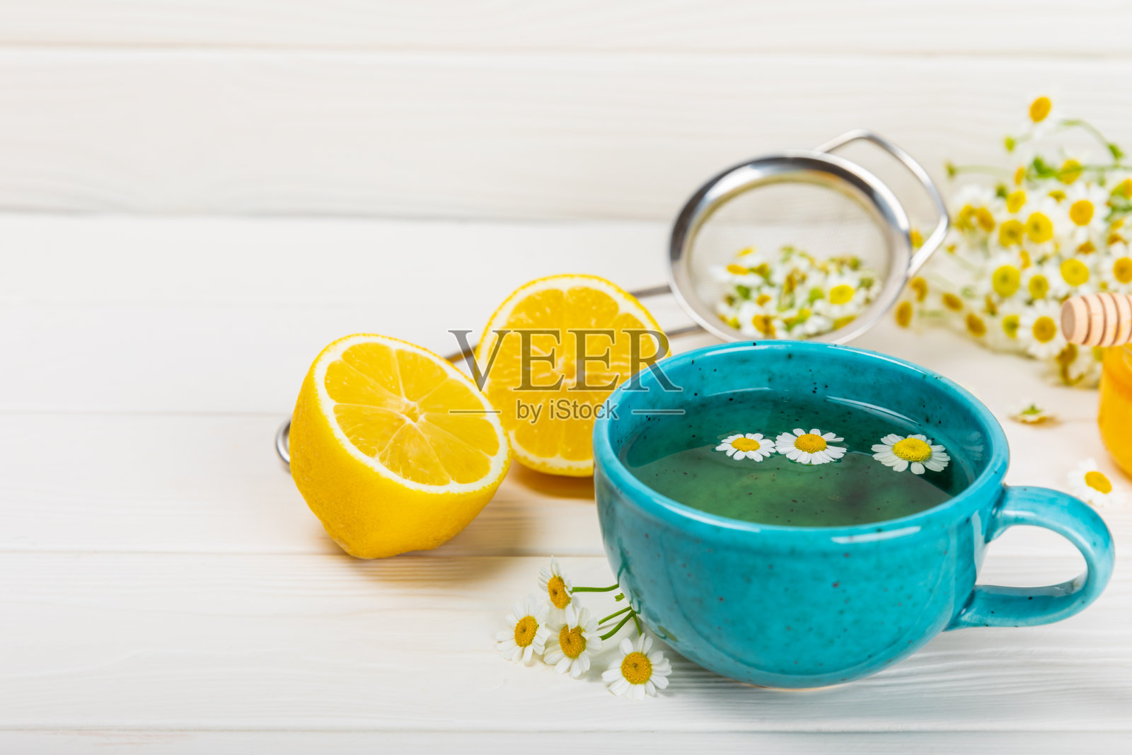 洋甘菊茶在一个杯子在白色纹理背景。菊花盛开的自然时光。花草茶。免疫茶。自然治疗师的概念。健康的排毒饮料。关闭了。放文字的地方。照片摄影图片