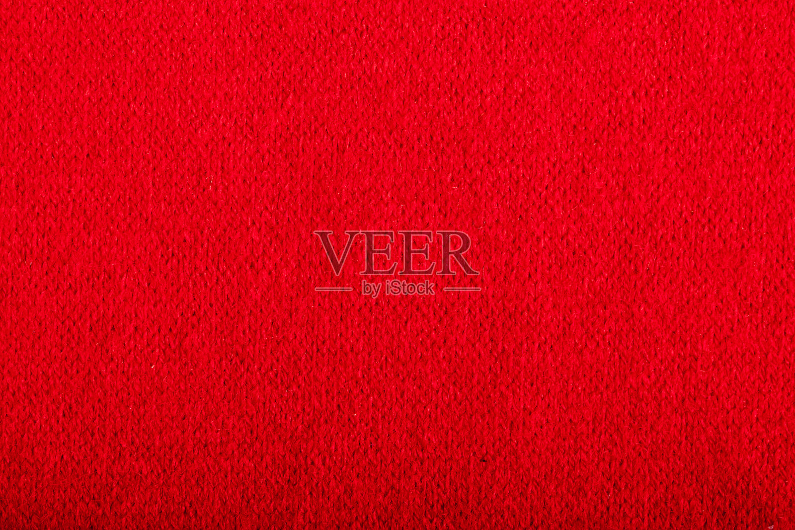 缝纫用红色羊毛织物。纺织品的背景。照片摄影图片