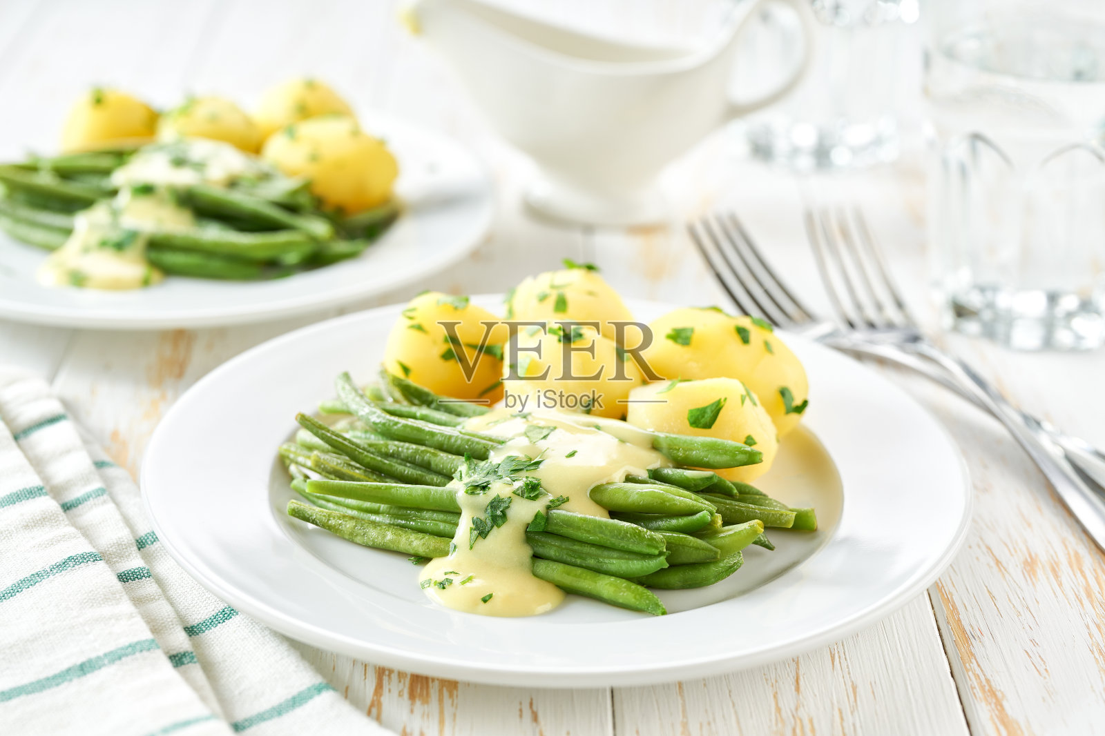 白桌青豆配奶油酱和煮土豆，选择性聚焦。素食，健康，干净的饮食。照片摄影图片