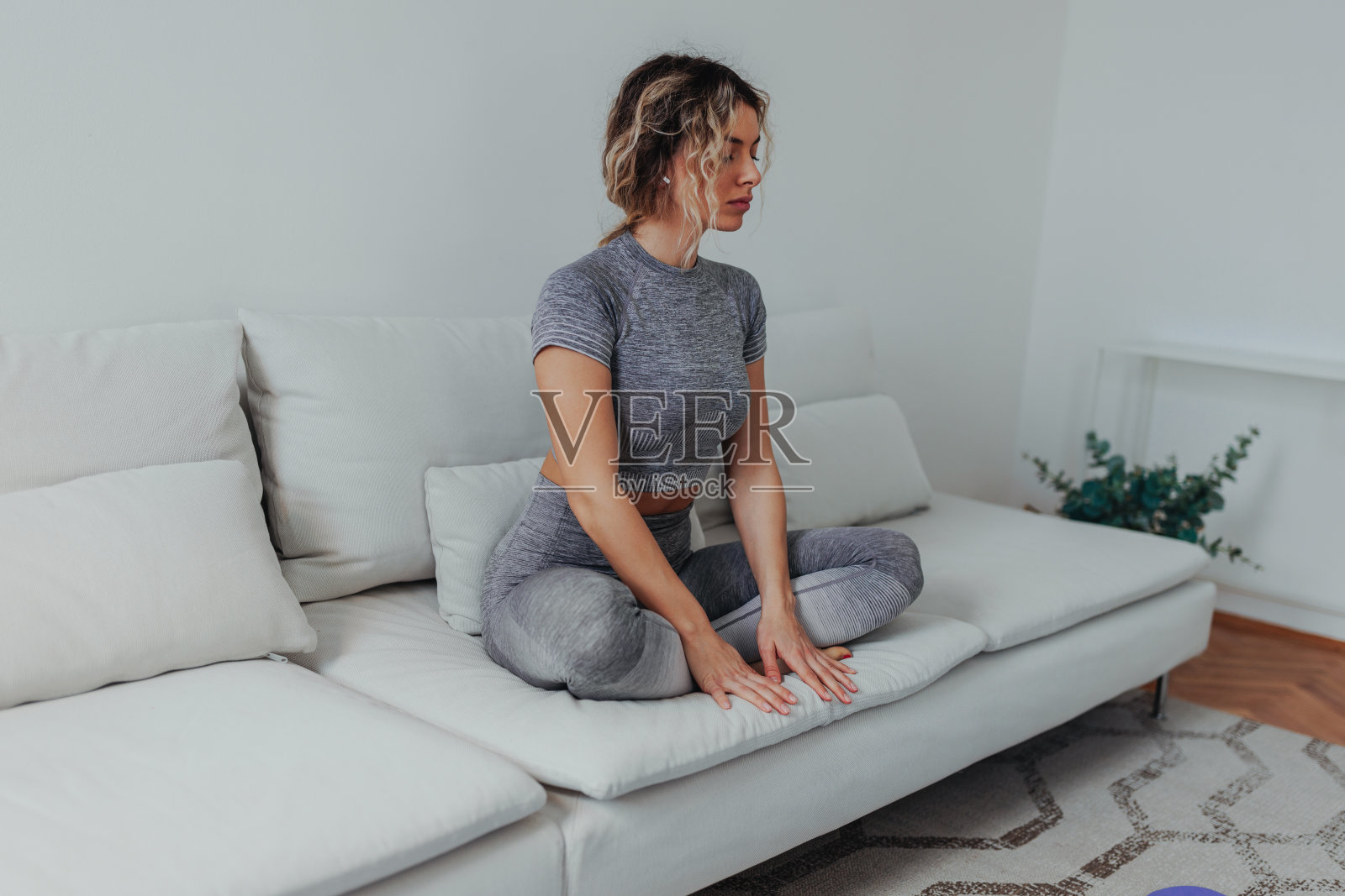 年轻女子在沙发上冥想照片摄影图片