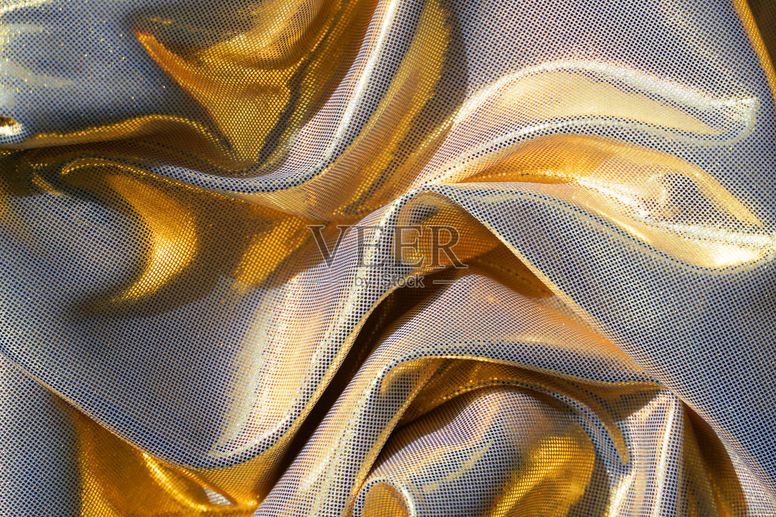 金色波纹织物。照片摄影图片