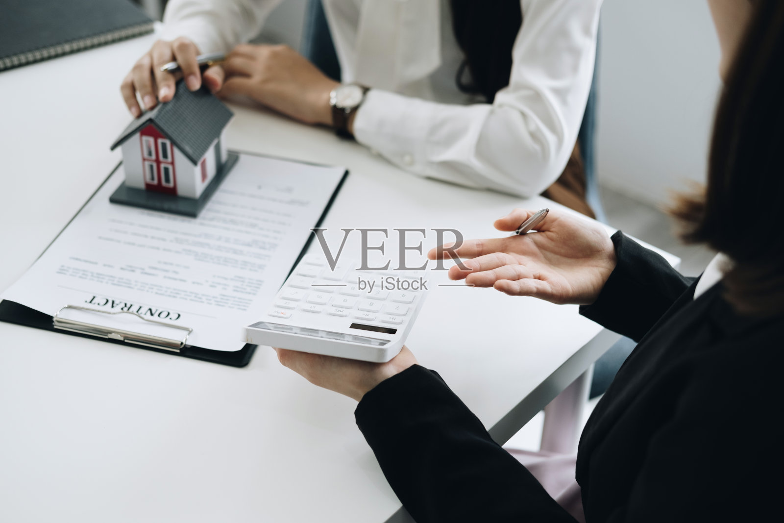 担保，抵押，合同，合同，签字，房地产经纪人或银行官员拿着计算器，提交一个出价，与客户购买一个房子，然后签署协议照片摄影图片