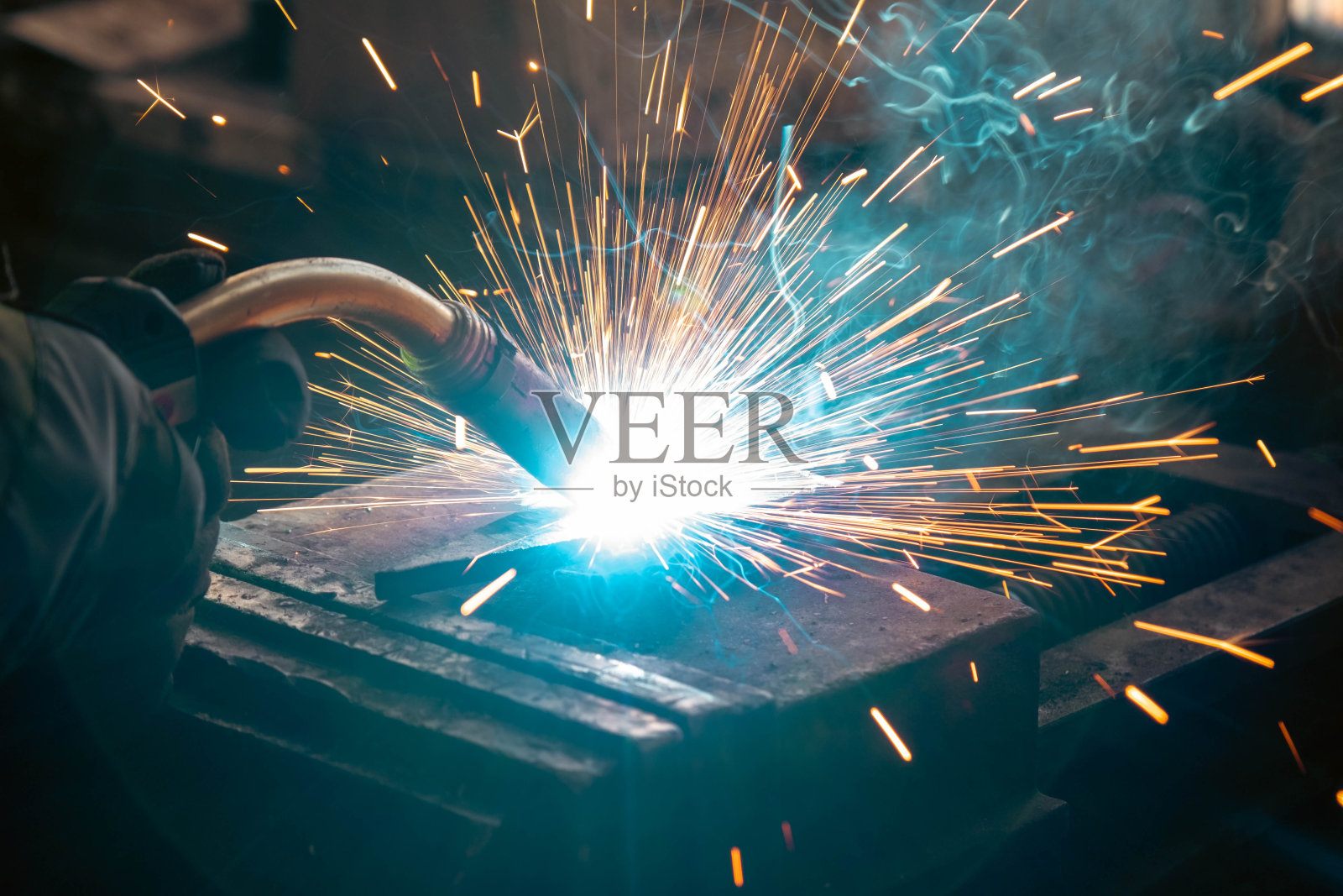 焊接钢材，火花四溅，不戴手套，淡得像烟花照片摄影图片