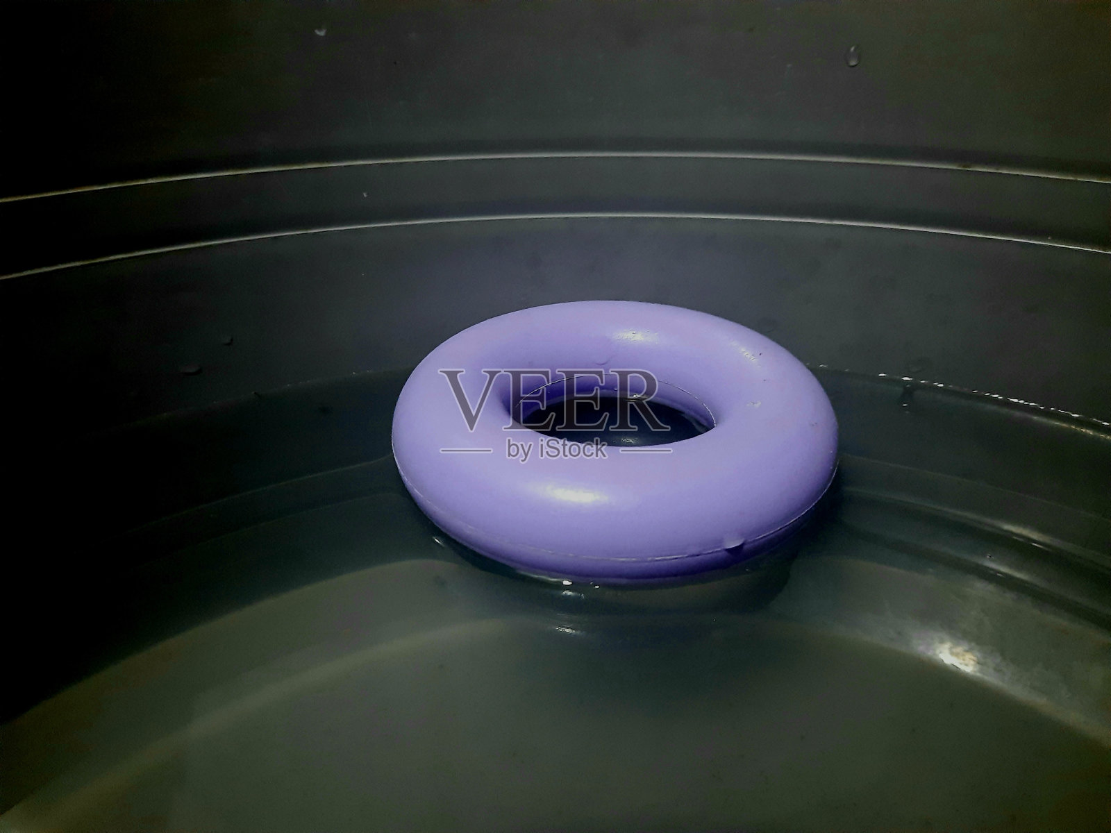 一个紫色的小浮标浮在水面上照片摄影图片