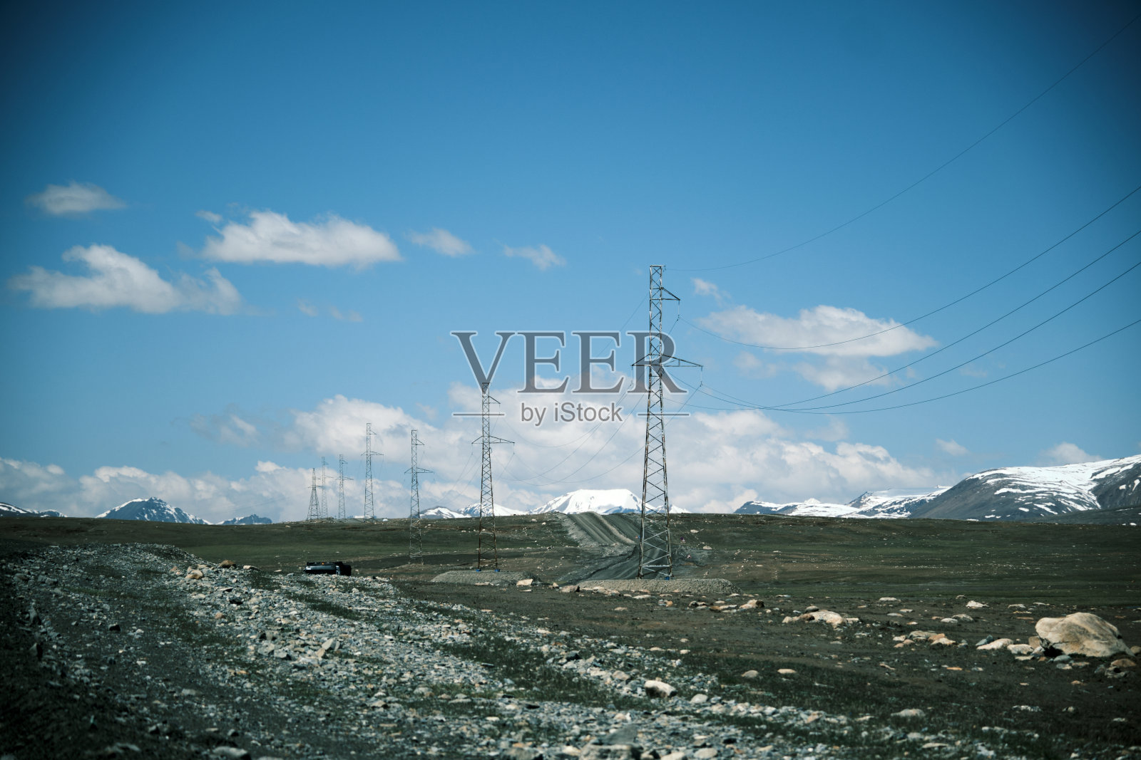 穿越南天山阿拉贝尔高原的公路上的电力管道照片摄影图片