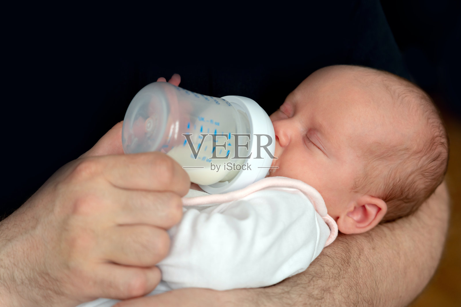 刚出生的小婴儿用奶瓶吃配方奶粉照片摄影图片