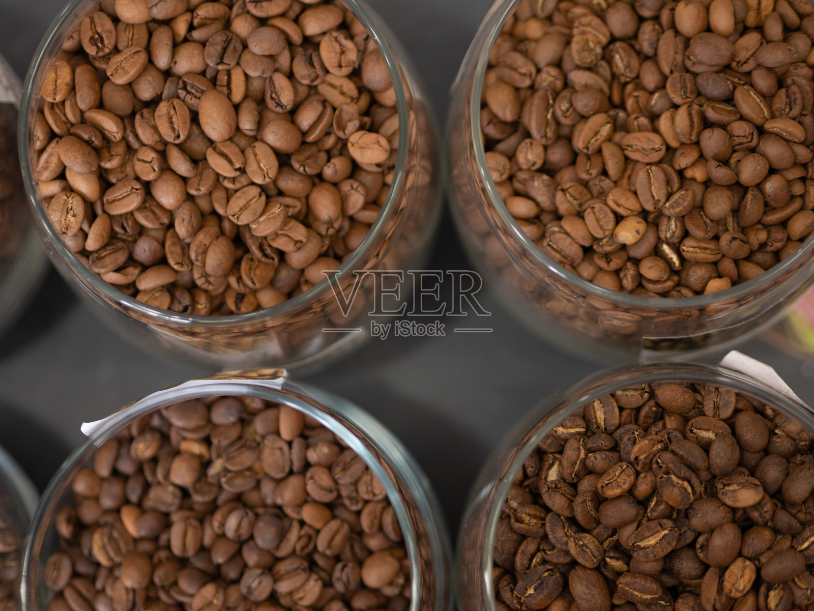 上面有很多装有咖啡豆的玻璃罐照片摄影图片