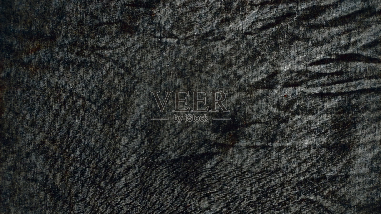 特写皱巴巴的加热器和运动服或有纹理织物背景的连帽衫照片摄影图片