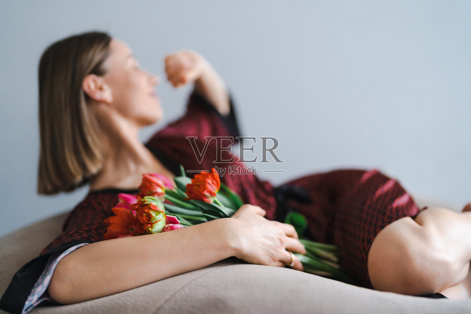 年轻女子享受花在家里放松的软豆袋照片摄影图片