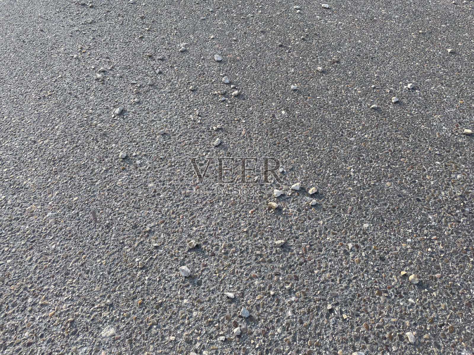 沥青上的石头。灰色纹理。照片摄影图片