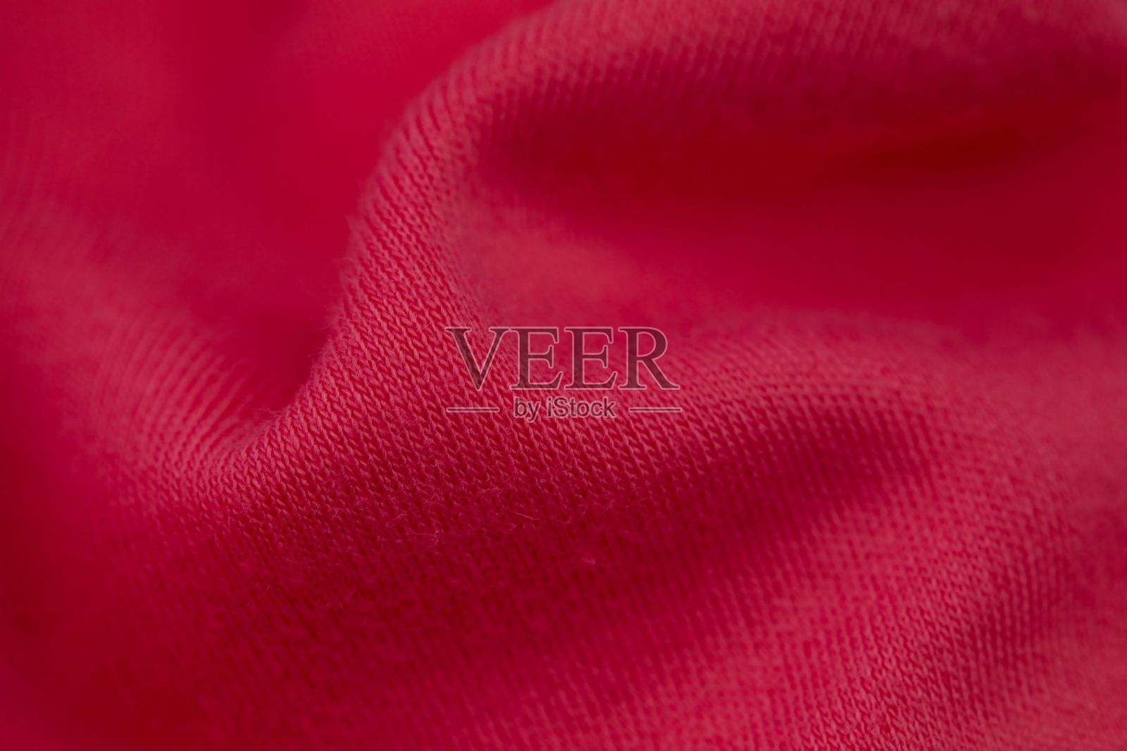 红色纺织毯的微距镜头，图案细致，质地柔软照片摄影图片