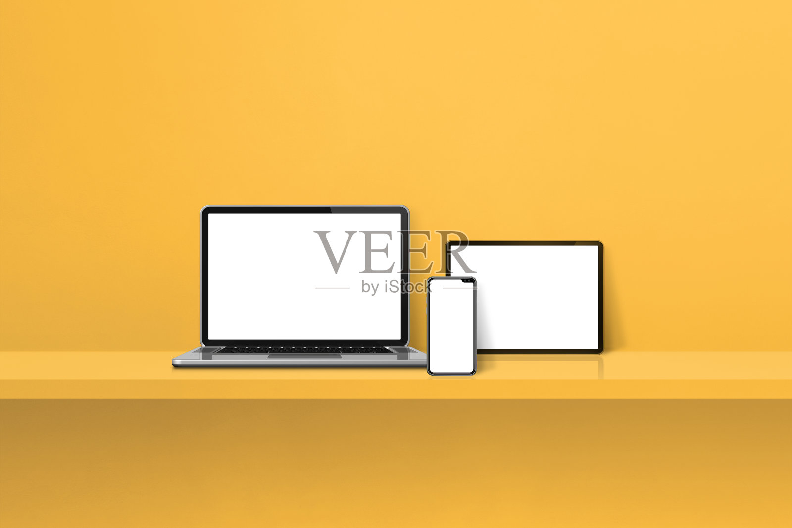 黄色的书架上放着笔记本电脑、手机和数码平板电脑。水平的背景照片摄影图片