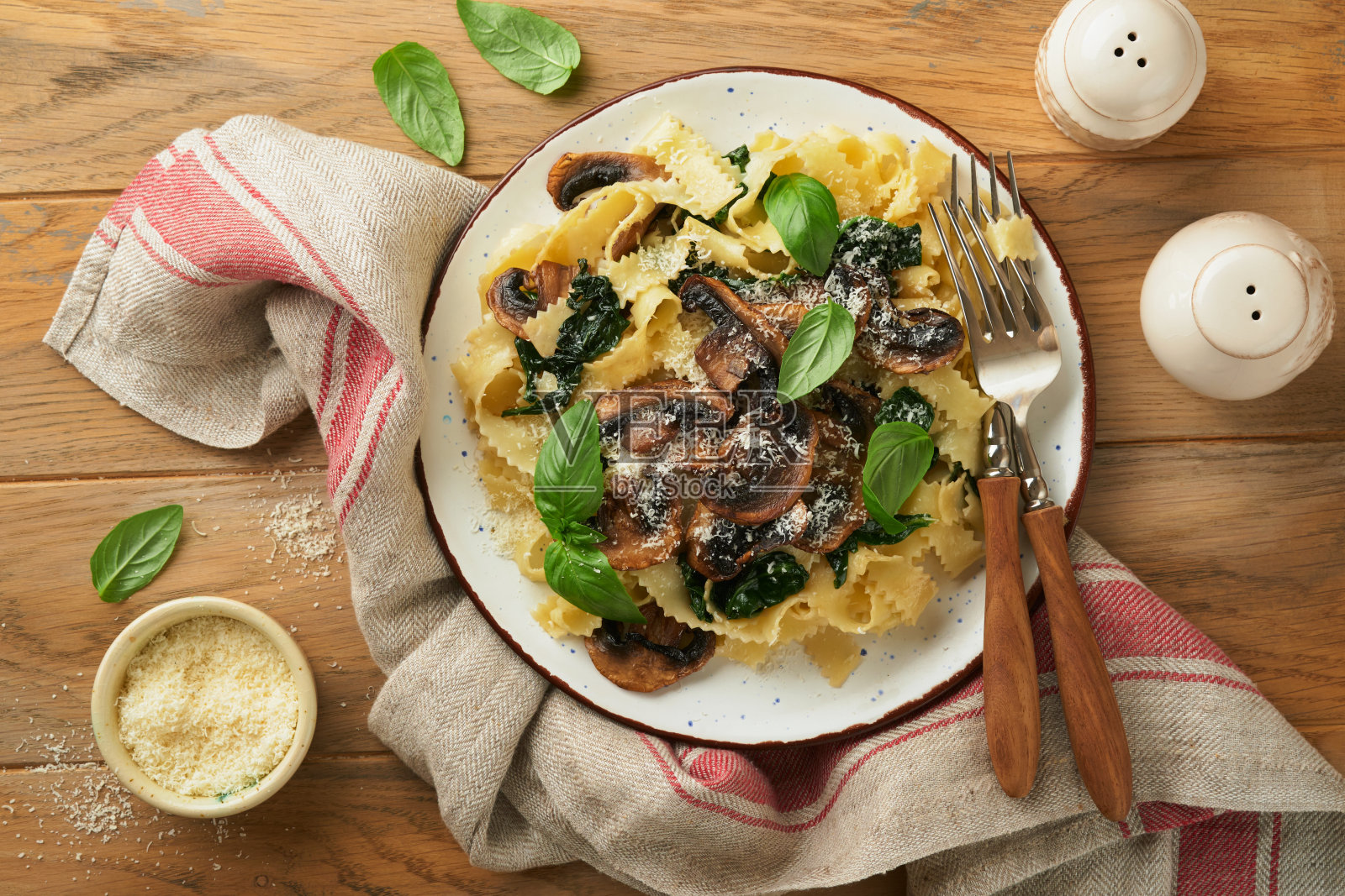 奶油阿尔弗雷多意大利面。意大利面，蘑菇，鸡肉，菠菜，罗勒和奶油酱在古老的乡村餐桌背景。传统的意大利菜。平的。本空间照片摄影图片