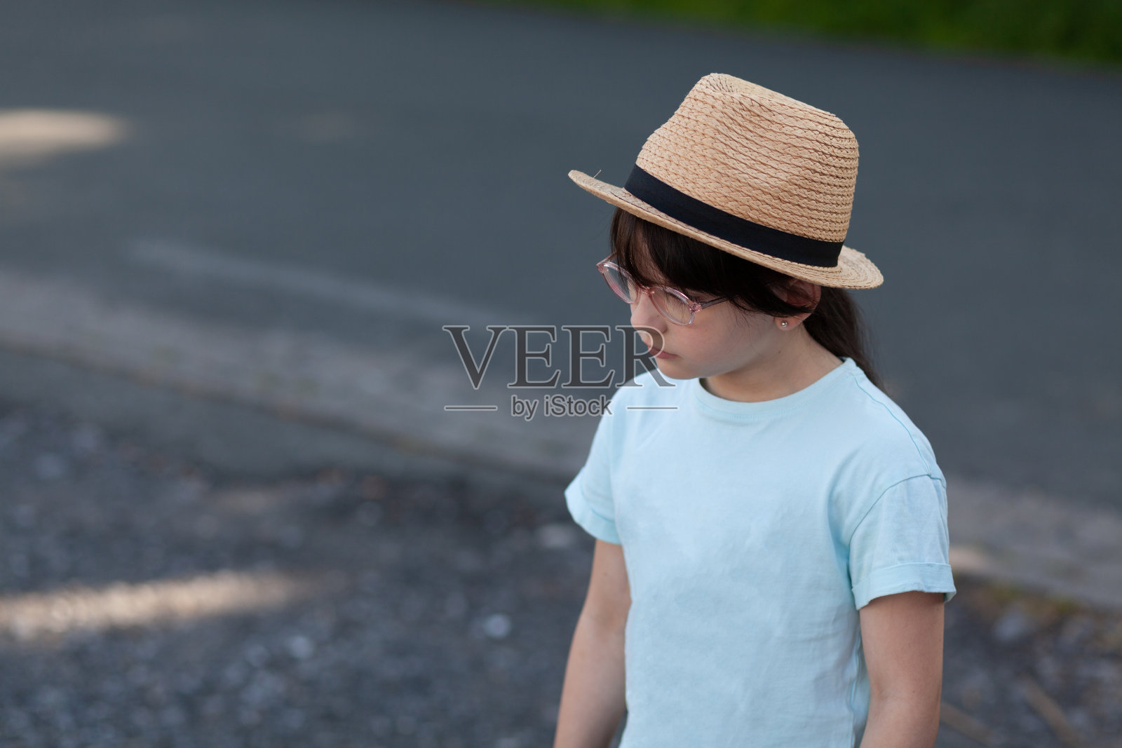 戴草帽穿蓝色t恤的小女孩的肖像照片摄影图片