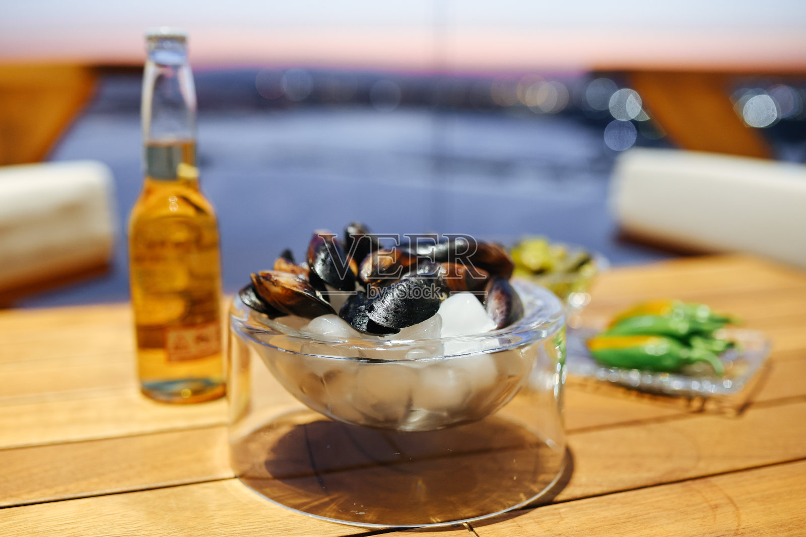 质朴的木桌上放着蒸贻贝和白葡萄酒照片摄影图片