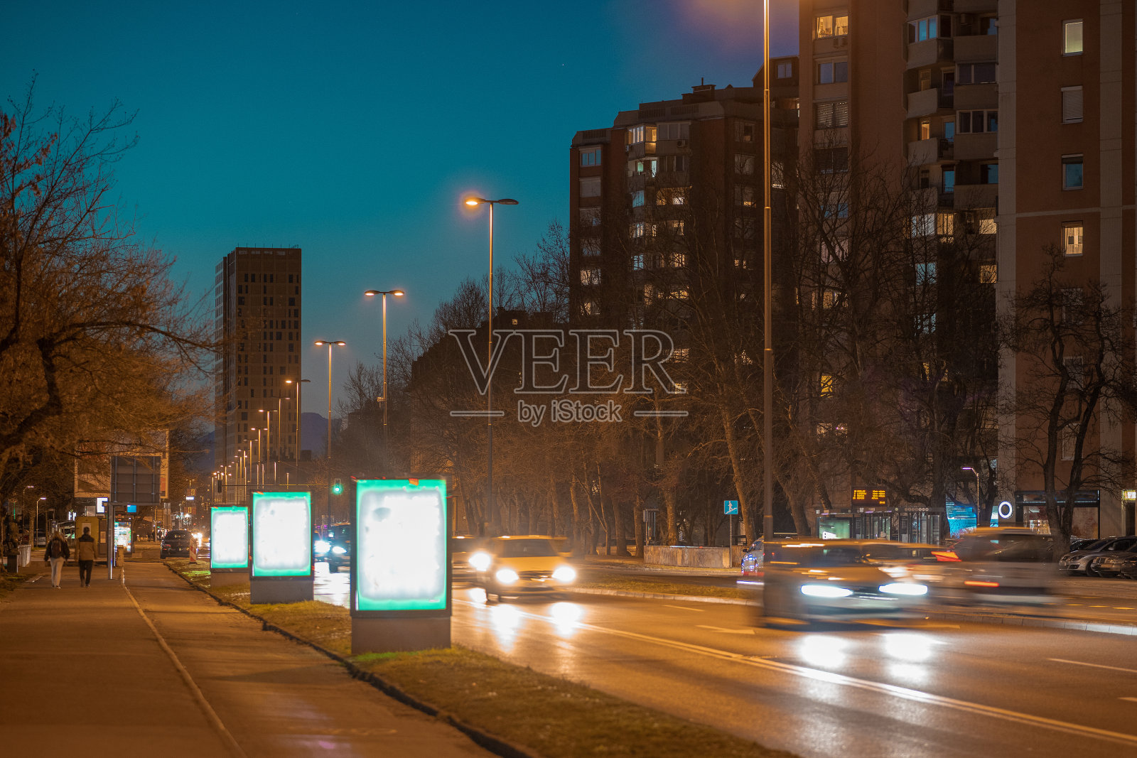 斯洛文尼亚卢布尔雅那的Celovska街道，夜晚的背景是正在建造的新摩天大楼。欧洲中部城市的夜间脉搏。照片摄影图片