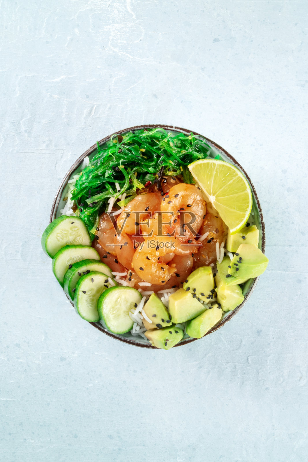 用牛油果、黄瓜、裙带菜和青柠泡虾碗照片摄影图片