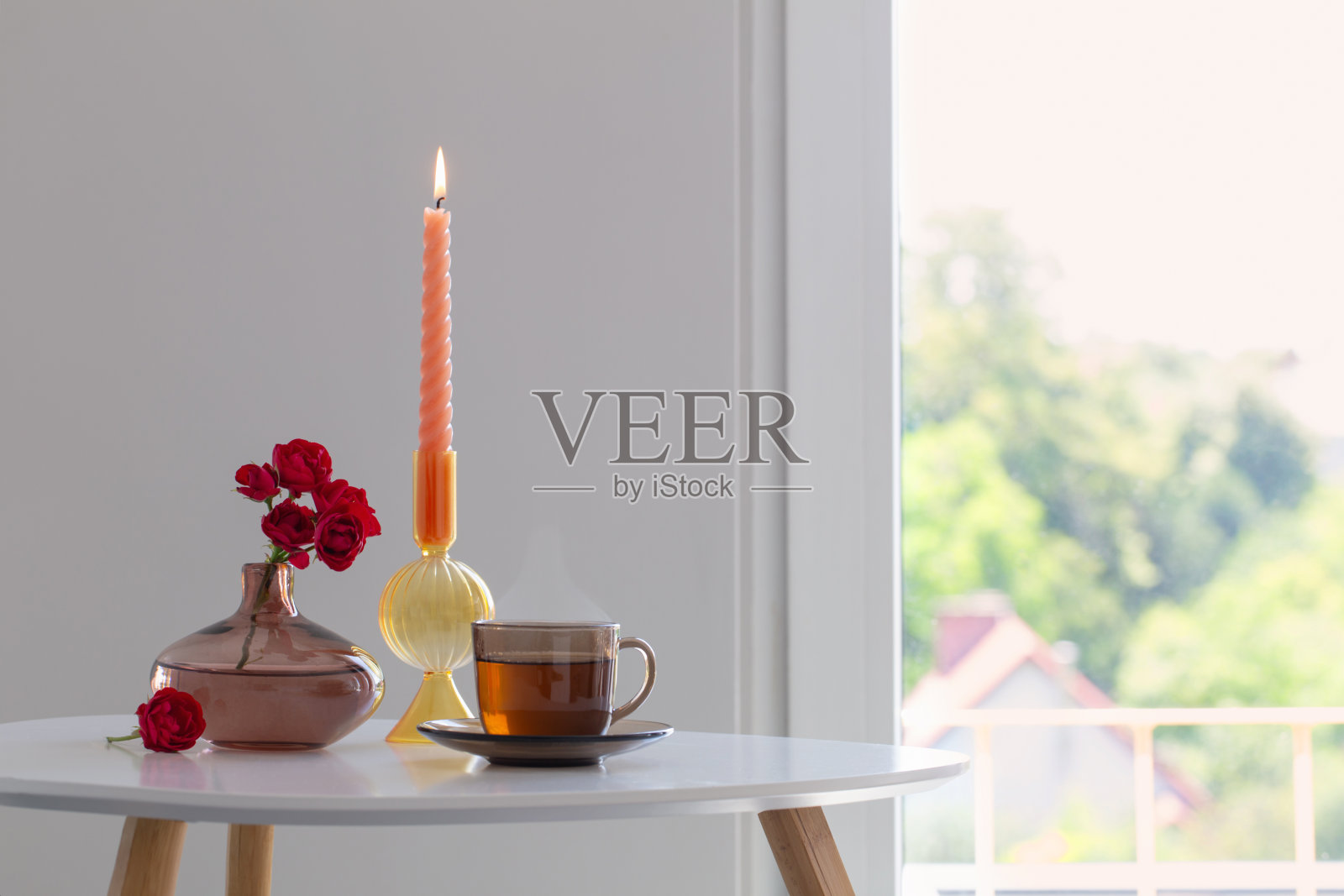 一杯茶和一束玫瑰在白色的内饰照片摄影图片