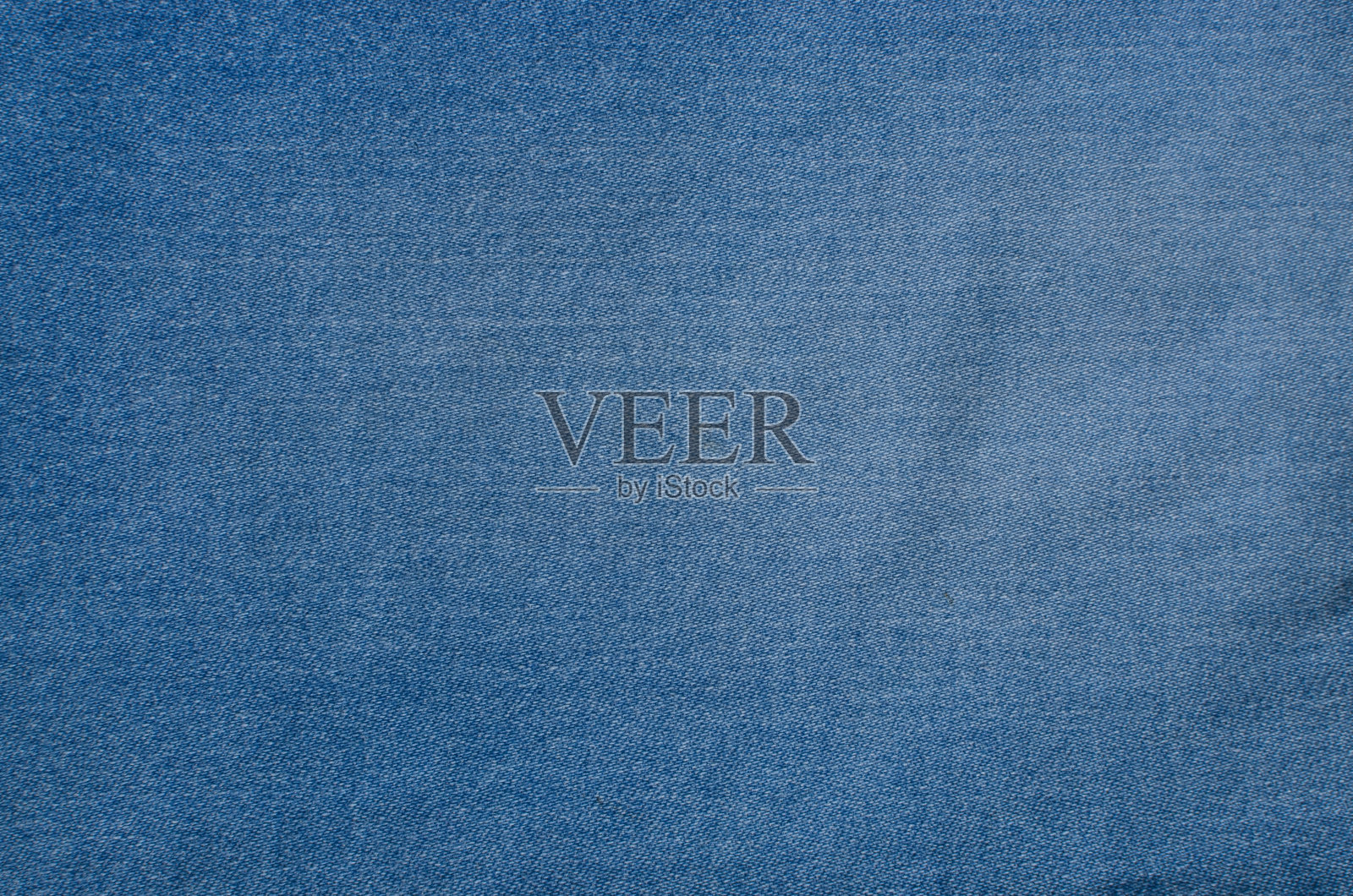 细节上的牛仔纹理特写，突出交织在一起的线条，增添了一丝原创性。非常适合时尚，风格和室内设计项目。照片摄影图片