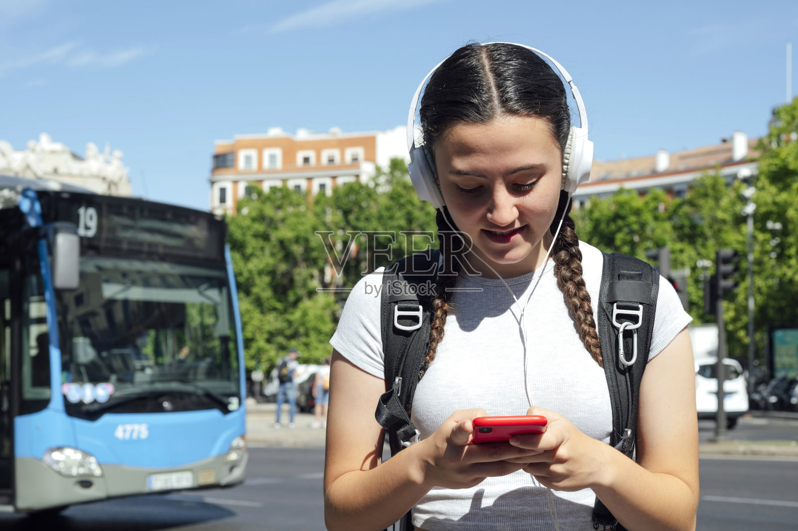 带着手机和耳机的都市女孩照片摄影图片