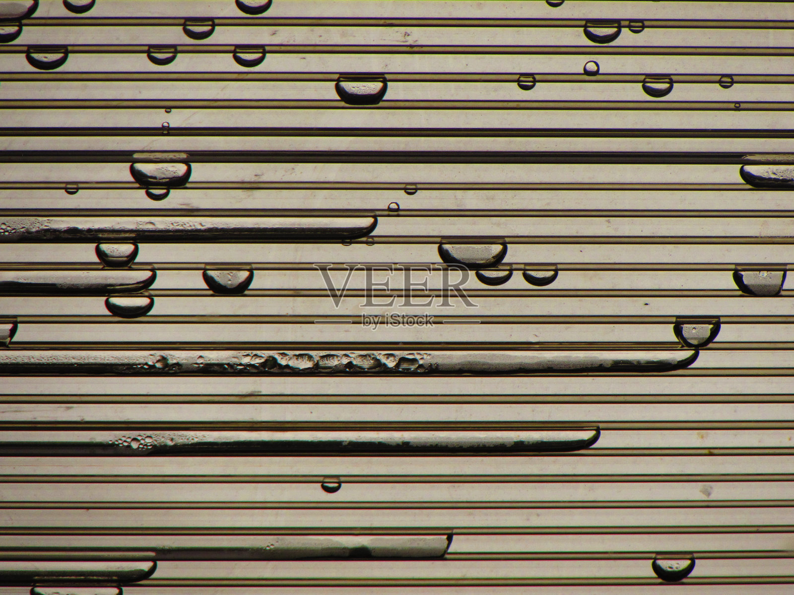 一扇窗户上有雨滴，上面写着“雨”。照片摄影图片