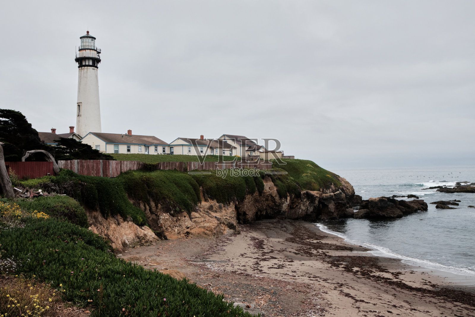 新英格兰风格的灯塔在阴暗的夜晚岩石悬崖上照片摄影图片
