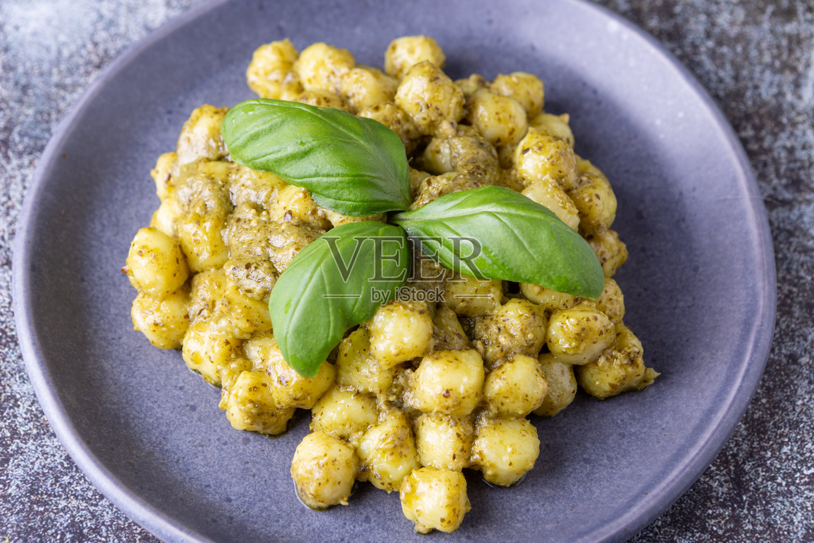 土豆汤圆配自制罗勒香蒜沙司。典型的意大利传统菜肴，适合素食者。照片摄影图片
