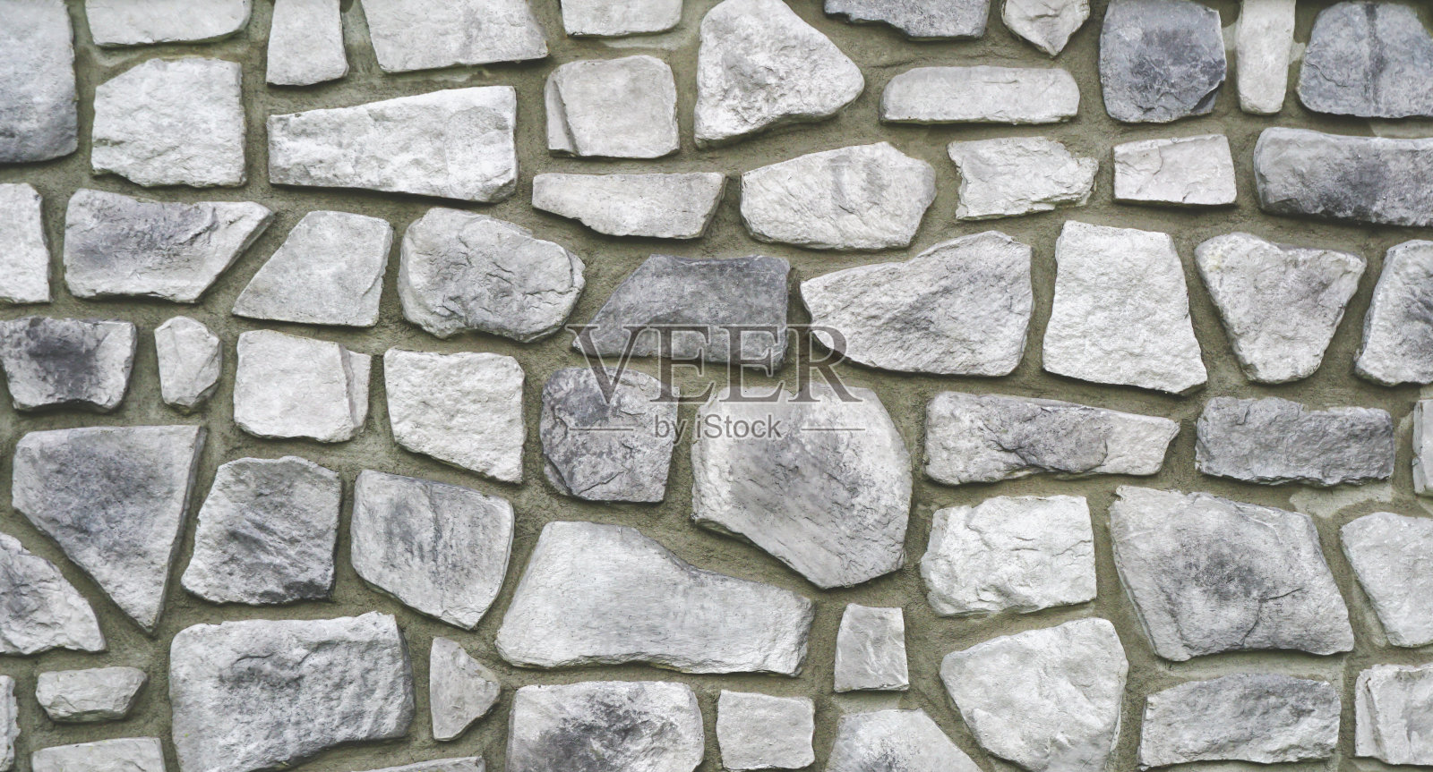 石墙纹理，抽象背景。灰色花岗岩墙背景。石墙的纹理背景是粗糙的堆叠。照片摄影图片