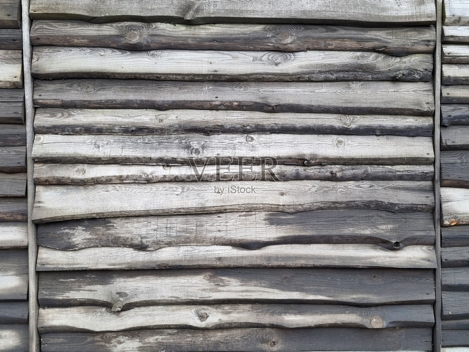 用木馏油处理过的木板水平切割成的巨大栅栏。树的一年生条纹的纹理背景图片。有选择性的重点照片摄影图片