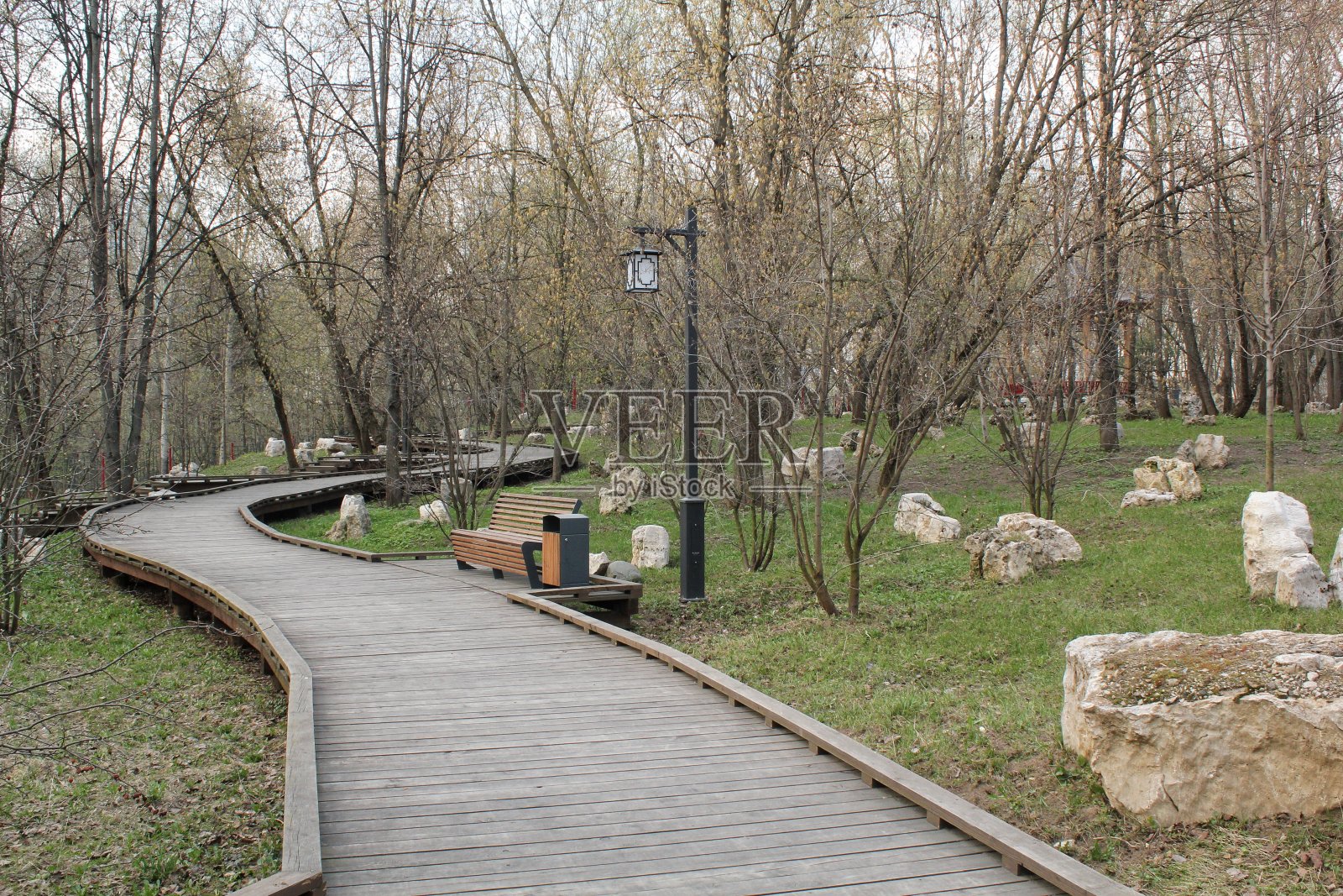 中国传统石园林中的木板路。公园内天然材料小径。休闲活动，远足理念。再生禅宗放松旅行。生态旅游照片摄影图片