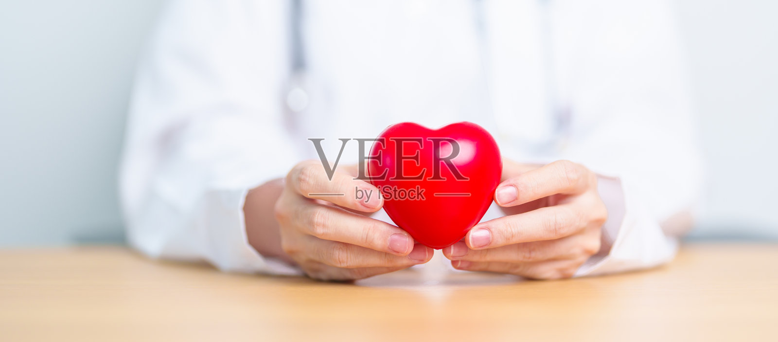 医院里，医生手握红心。爱，捐赠，世界心脏日，世界卫生日，企业社会责任捐赠和保险概念照片摄影图片