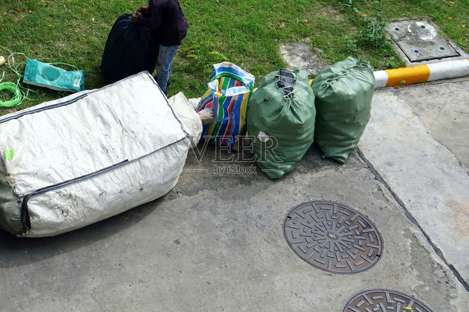 一名工人正在车上收集垃圾袋以便回收。照片摄影图片