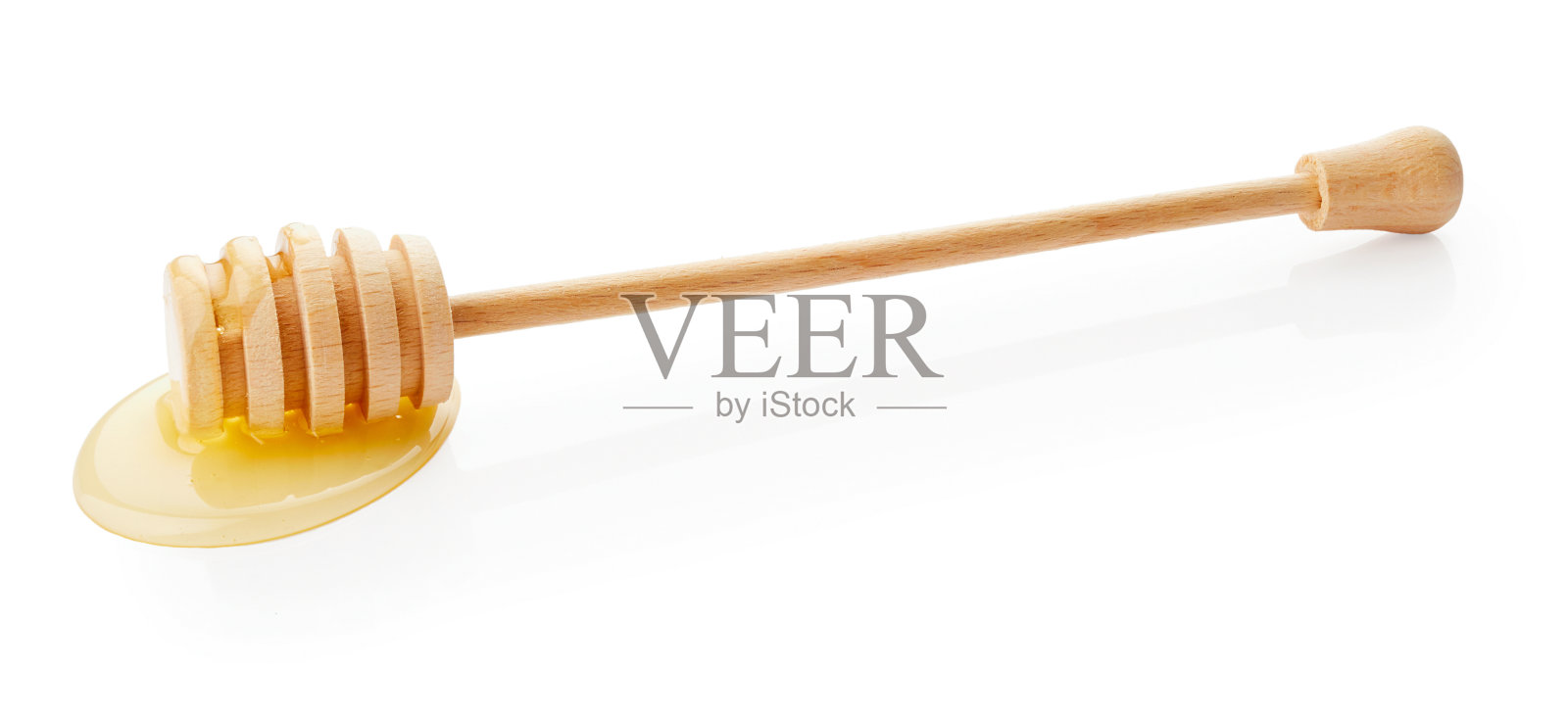 蜂蜜从木棒上滴下来照片摄影图片