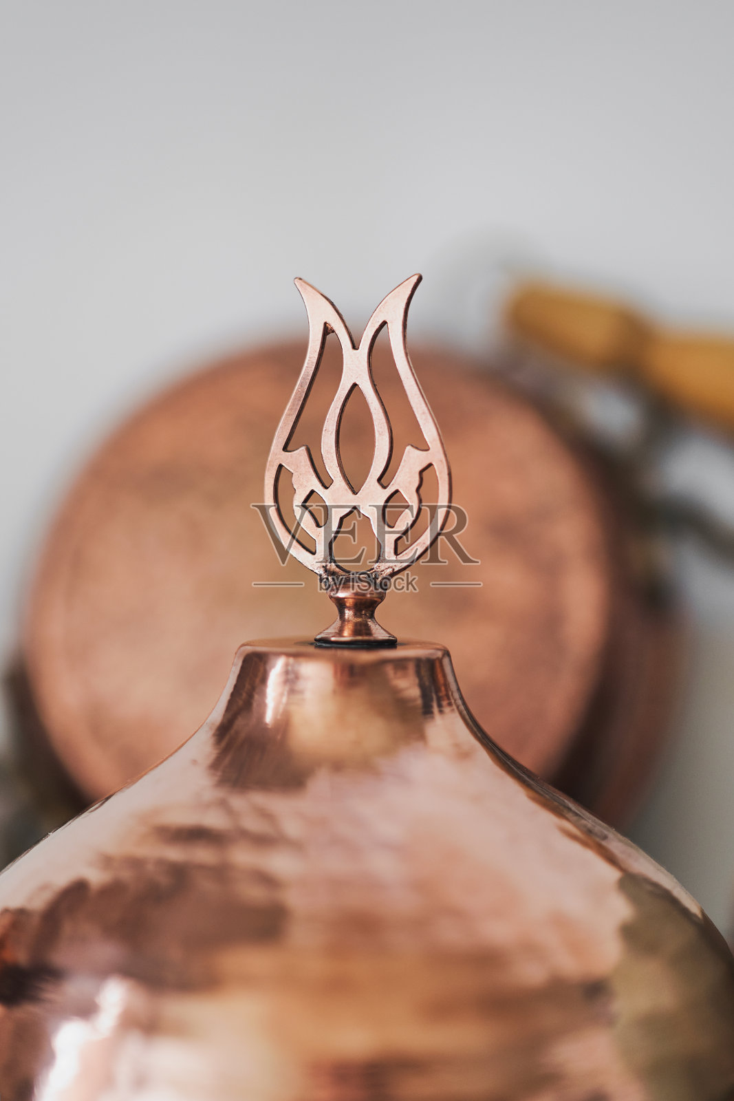 在家里的厨房或餐厅的架子上，传统的土耳其铜制餐具上的盖子的细节，选择性的聚焦。传统的工艺品。照片摄影图片