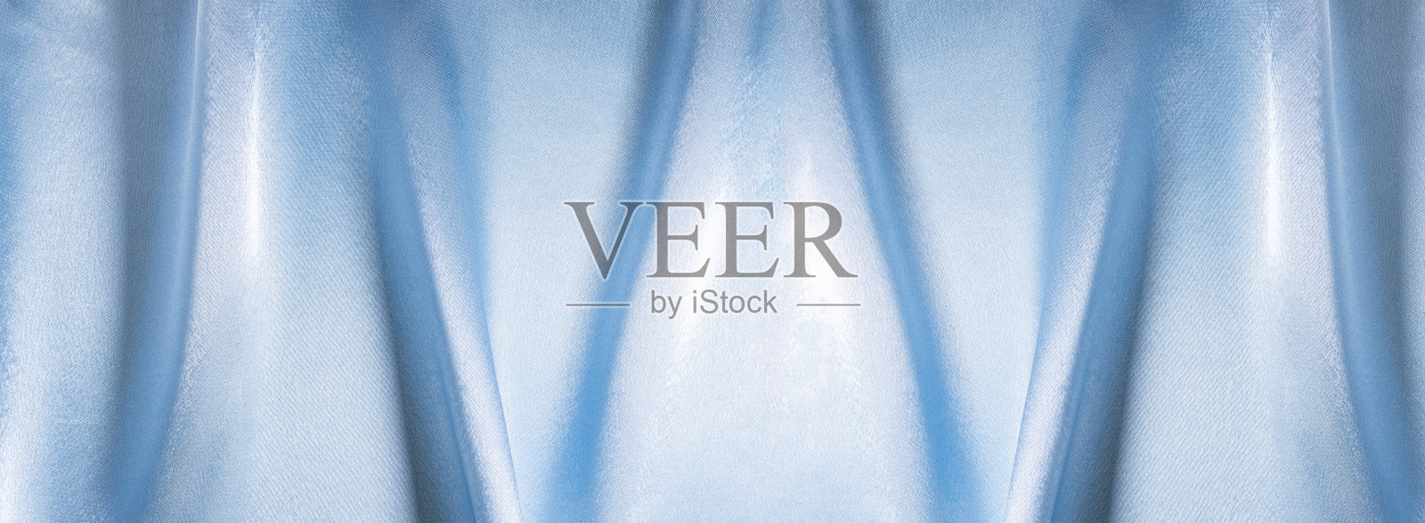 面料的蓝色纹理带有波浪特写，图案或天然面料的浅蓝色纹理照片摄影图片