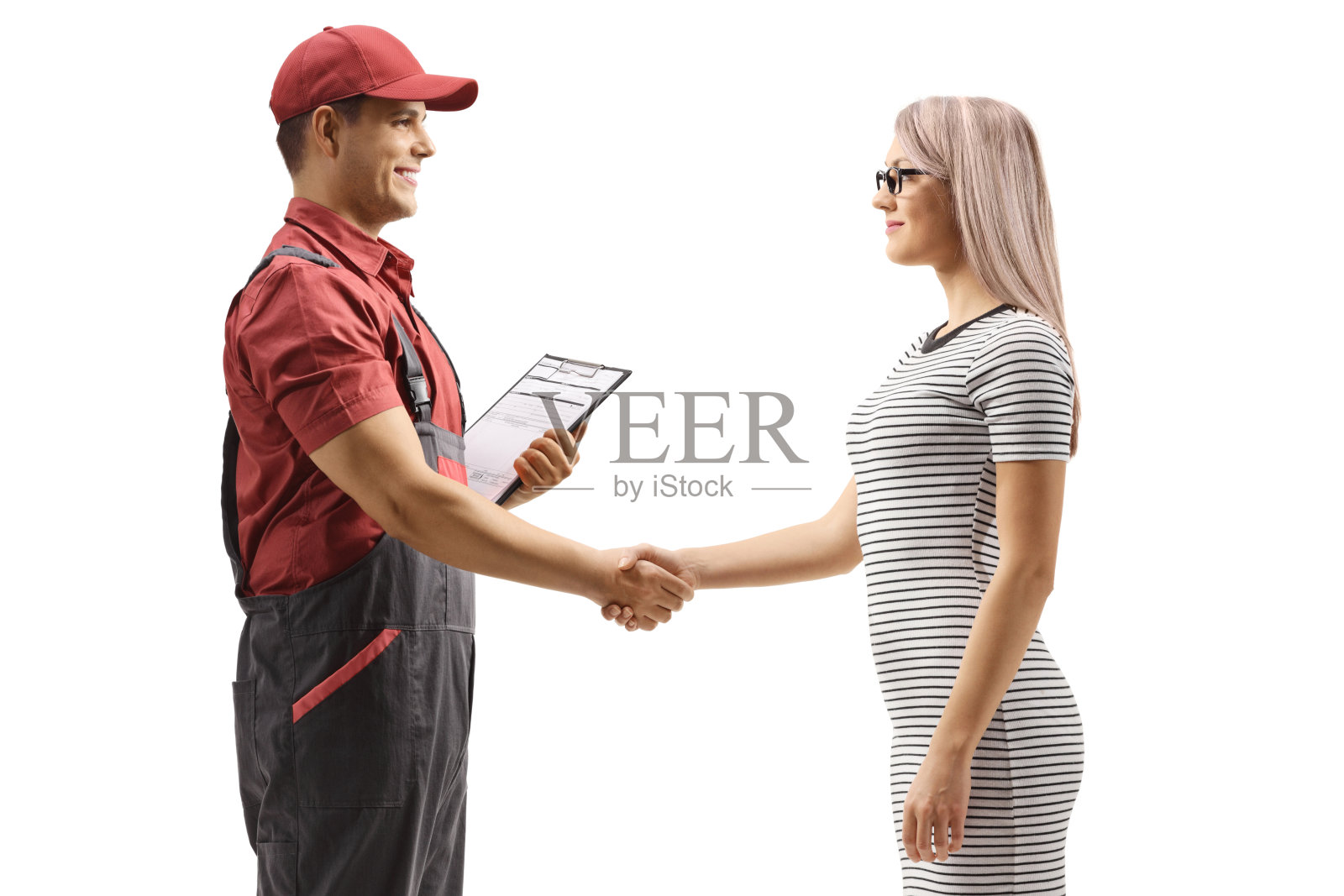 快递员正在和一位年轻女子握手照片摄影图片