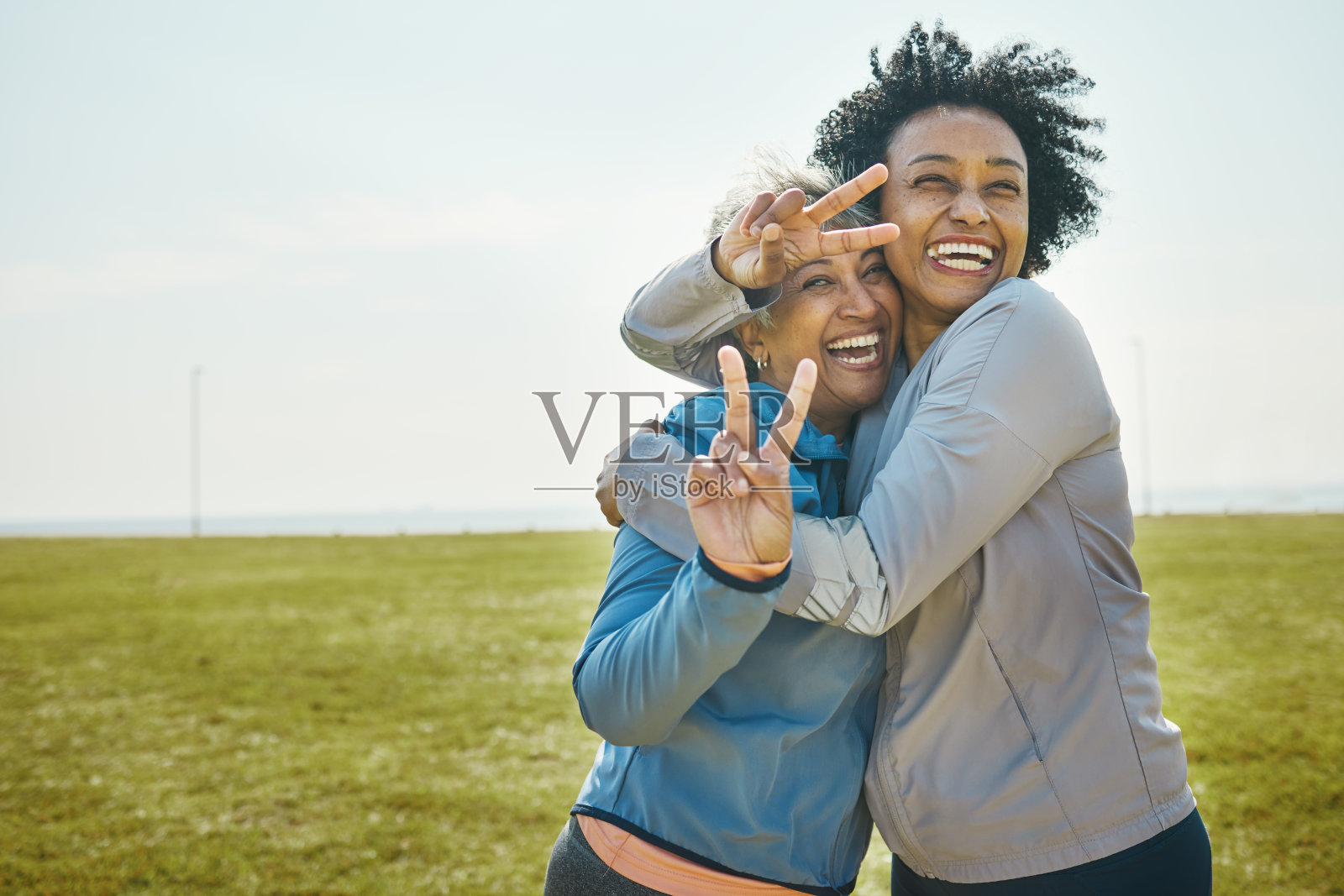 高级，女性拥抱和健身，和平的手势和肖像与朋友，精力和好玩的户外。快乐的女人们，友谊与清凉伴着运动服在公园里玩耍，一起锻炼与玩乐照片摄影图片