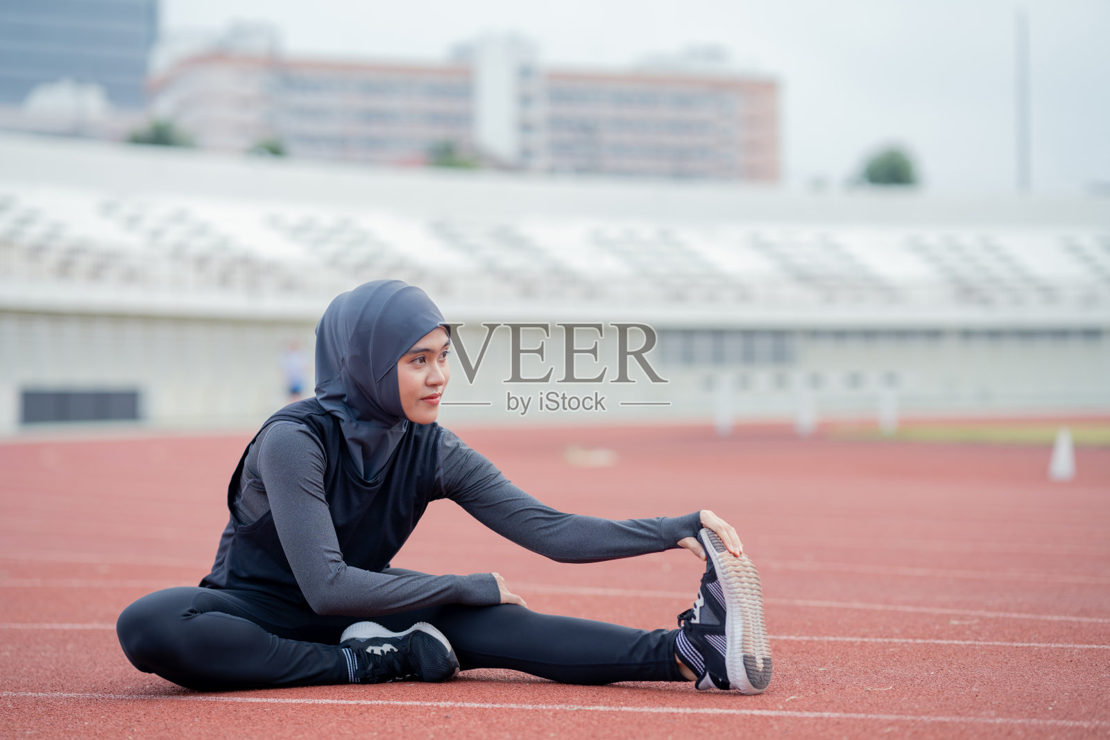 一位戴着黑色头巾的年轻亚洲穆斯林妇女正在锻炼和跑步照片摄影图片
