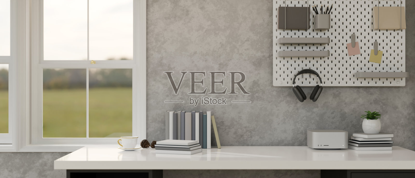 现代阁楼家庭工作空间，白色的桌子对着灰色的阁楼墙照片摄影图片