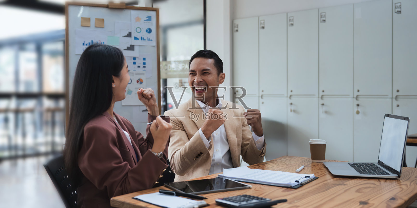 亚洲人对自己的工作充满决心和激情。商业成功的公司。与合作伙伴成功合作后，亚洲商业团队微笑着举起手臂照片摄影图片