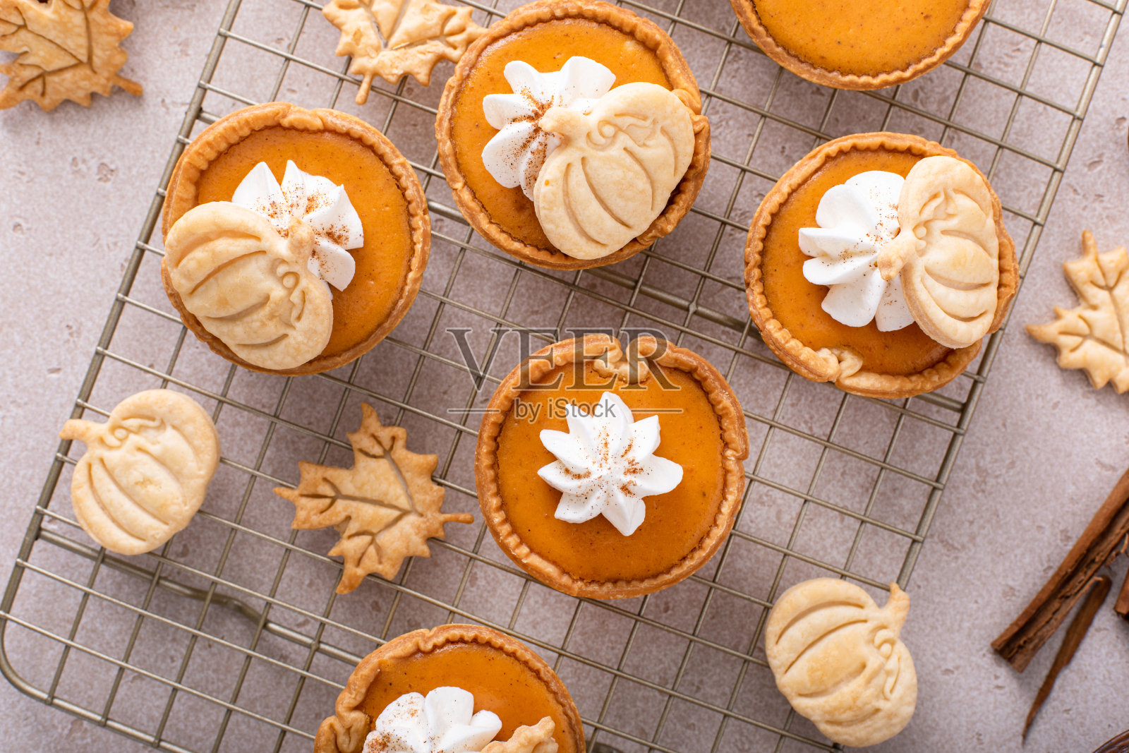 用南瓜和落叶装饰的迷你南瓜派照片摄影图片