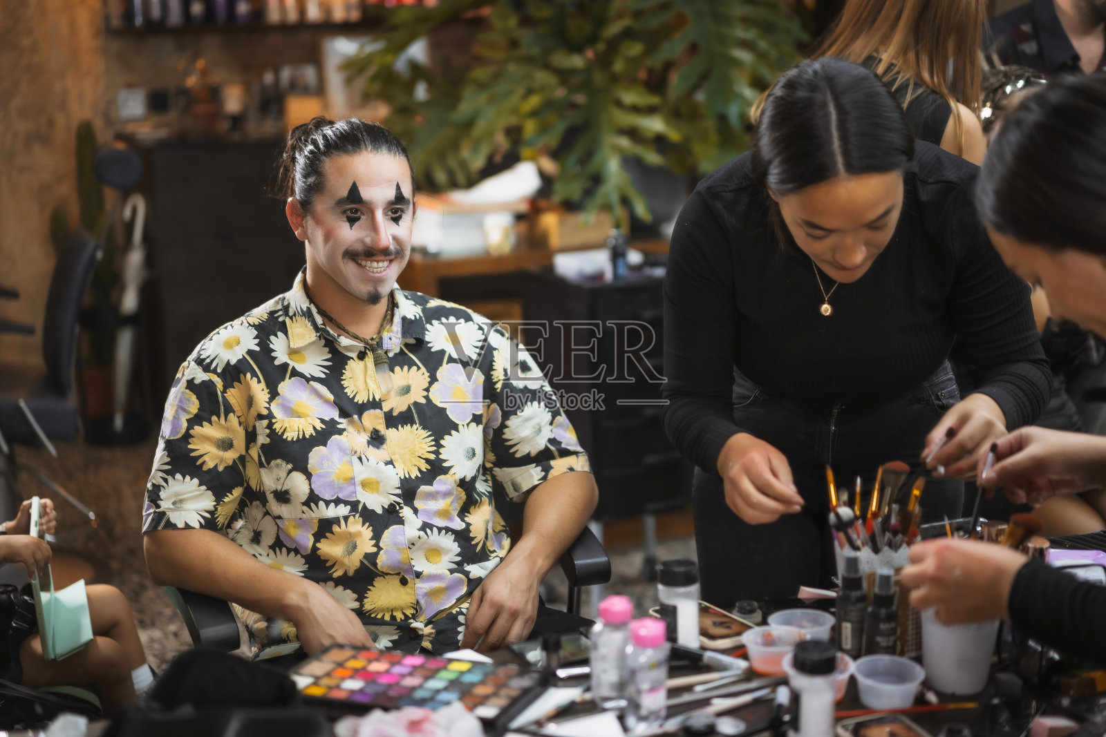 万圣节派对准备，化妆师在美容院为客户完成化妆照片摄影图片