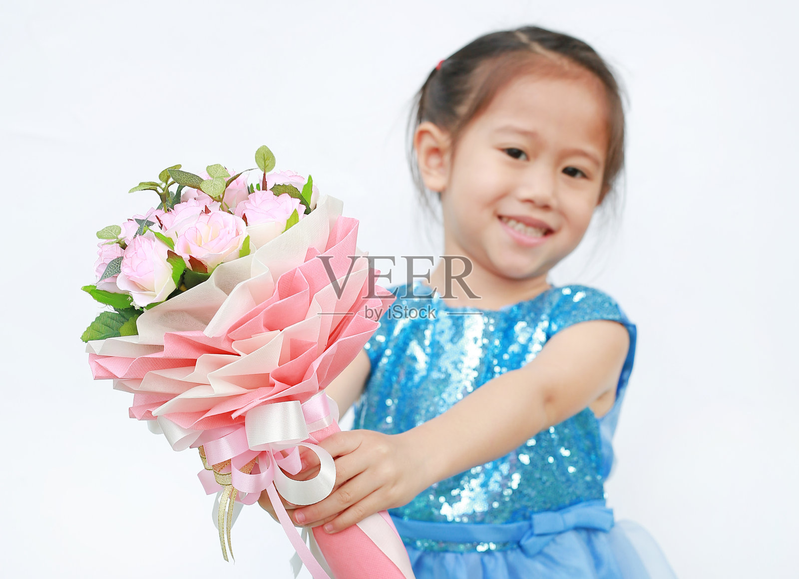 一个可爱的小女孩的肖像与一束玫瑰孤立的白色背景。照片摄影图片