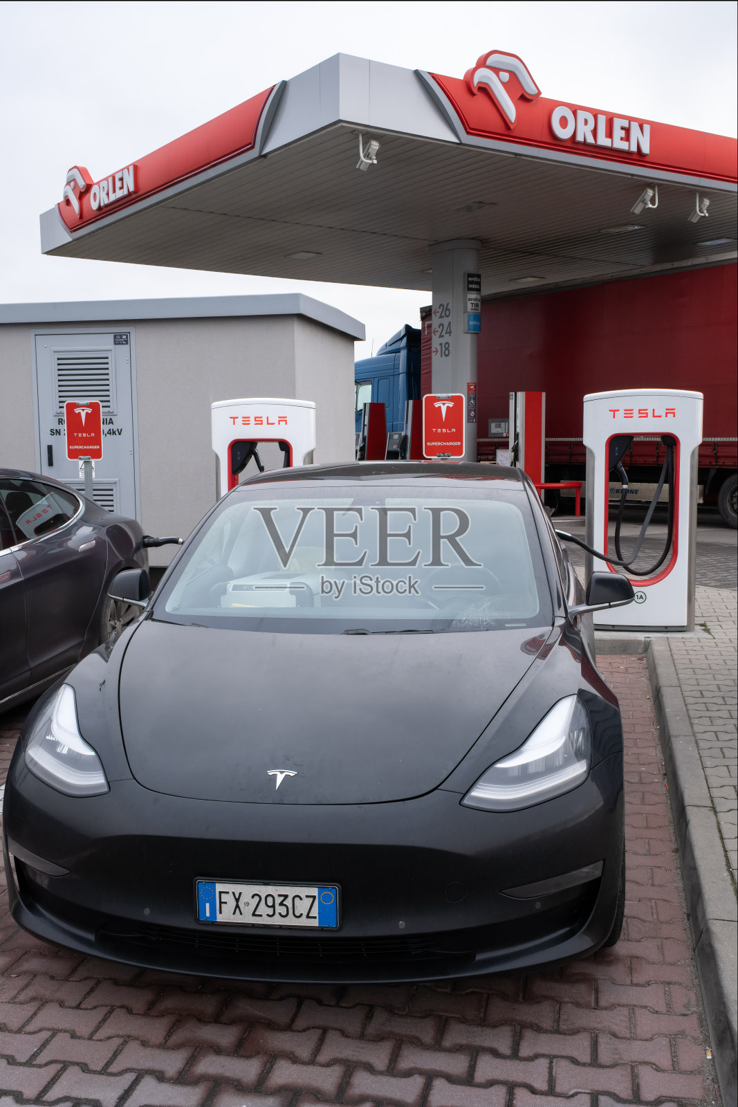 冬季在超级充电站充电的黑色特斯拉Model 3双电机长续航全轮驱动汽车的静态照片,选择性聚焦照片摄影图片