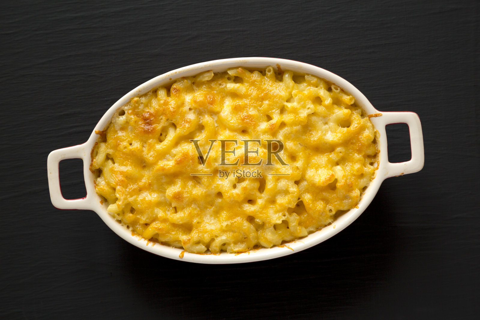 自制的通心粉和奶酪通心粉在黑色背景，俯视图。平躺，头顶上，从上面。照片摄影图片