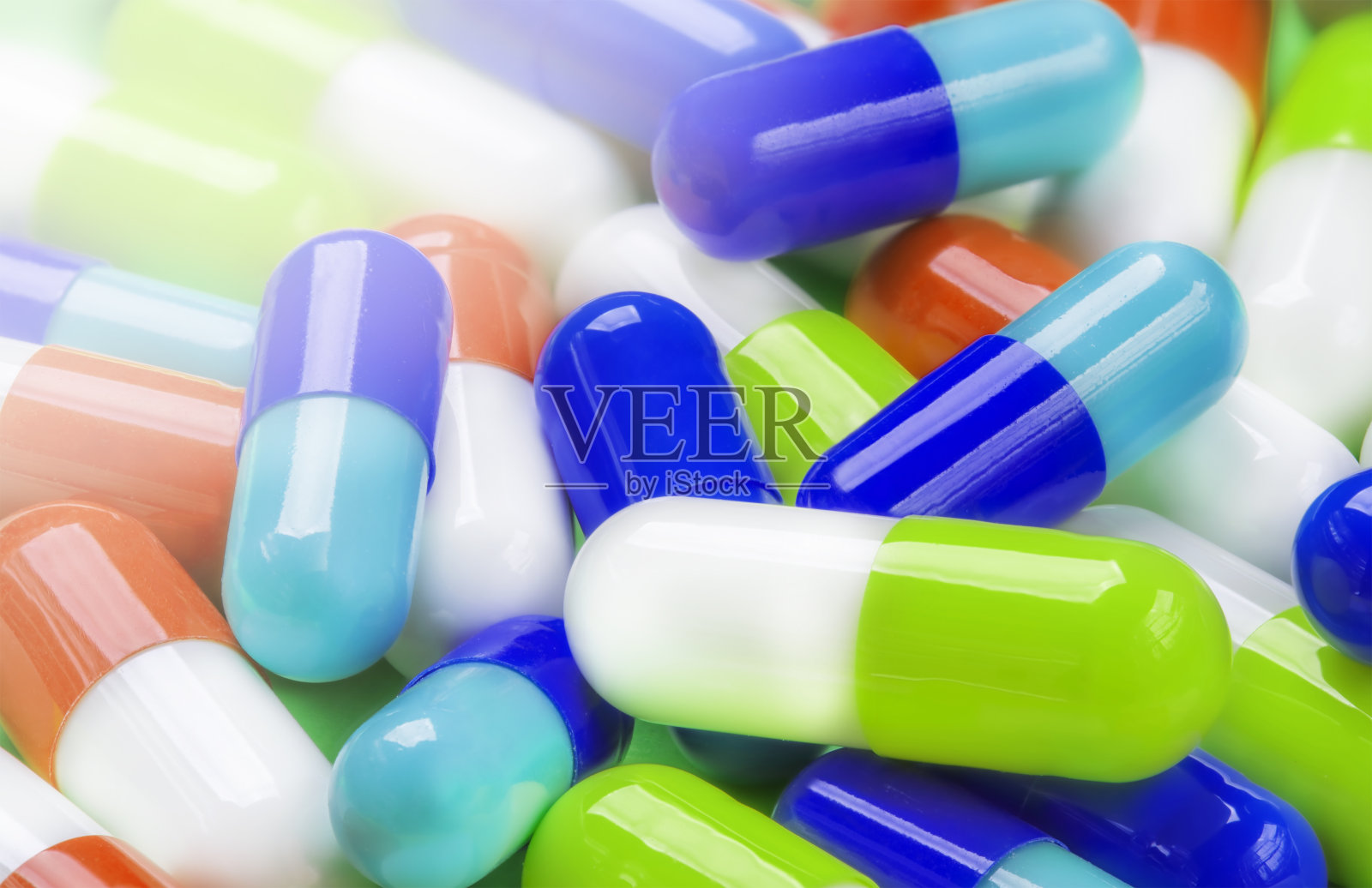 不同疾病和病毒的不同颜色药丸的背景照片摄影图片