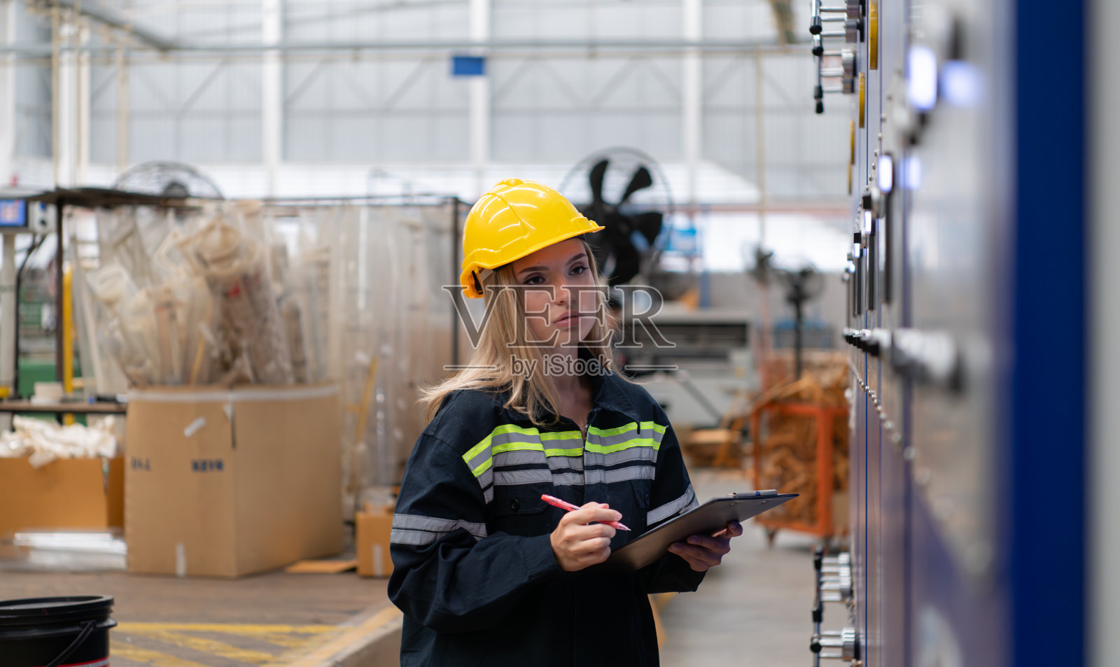 女工程师检查机器电路板的运行情况。照片摄影图片